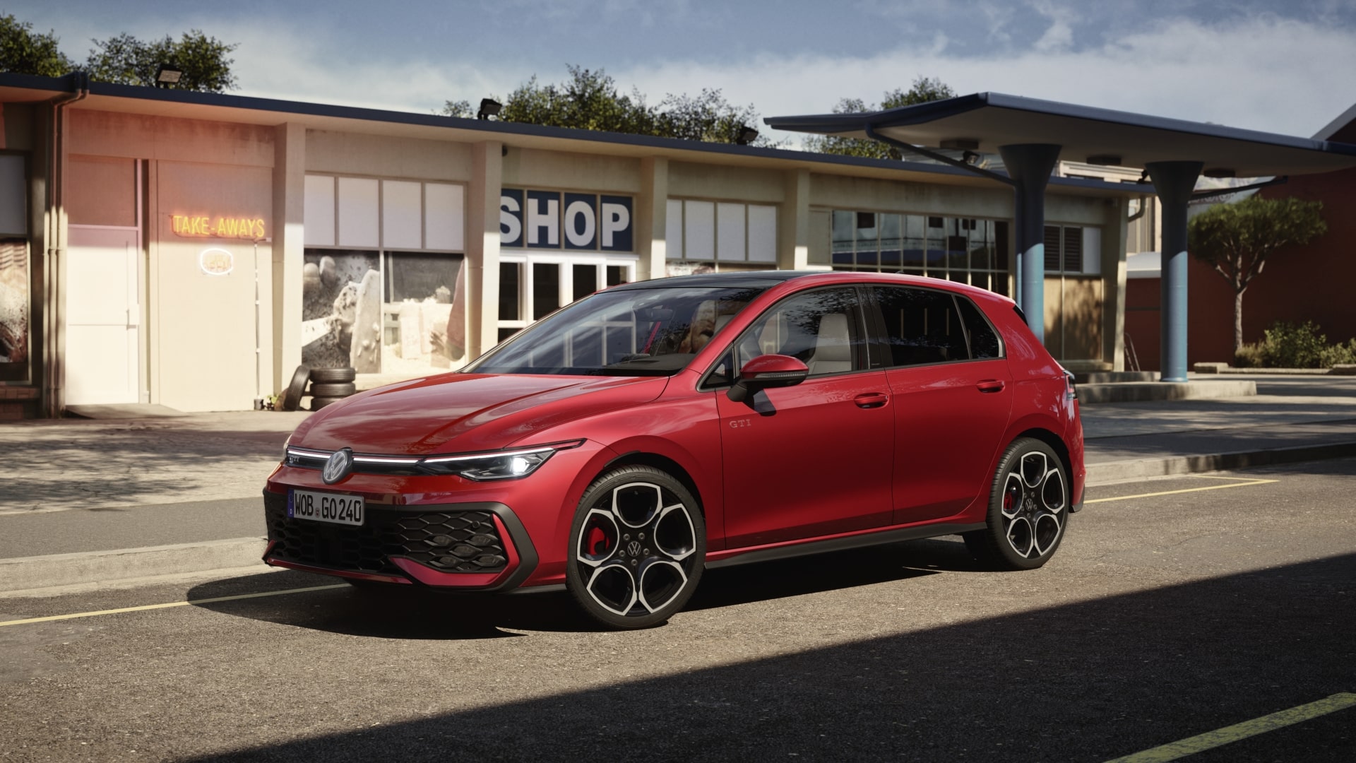 Red Volkswagen Golf GTI parked in front of a shop.