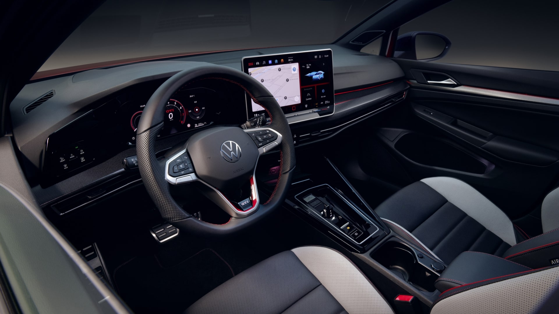 Interior view of the Volkswagen Golf GTI's driver's area, showing the steering wheel and dashboard.