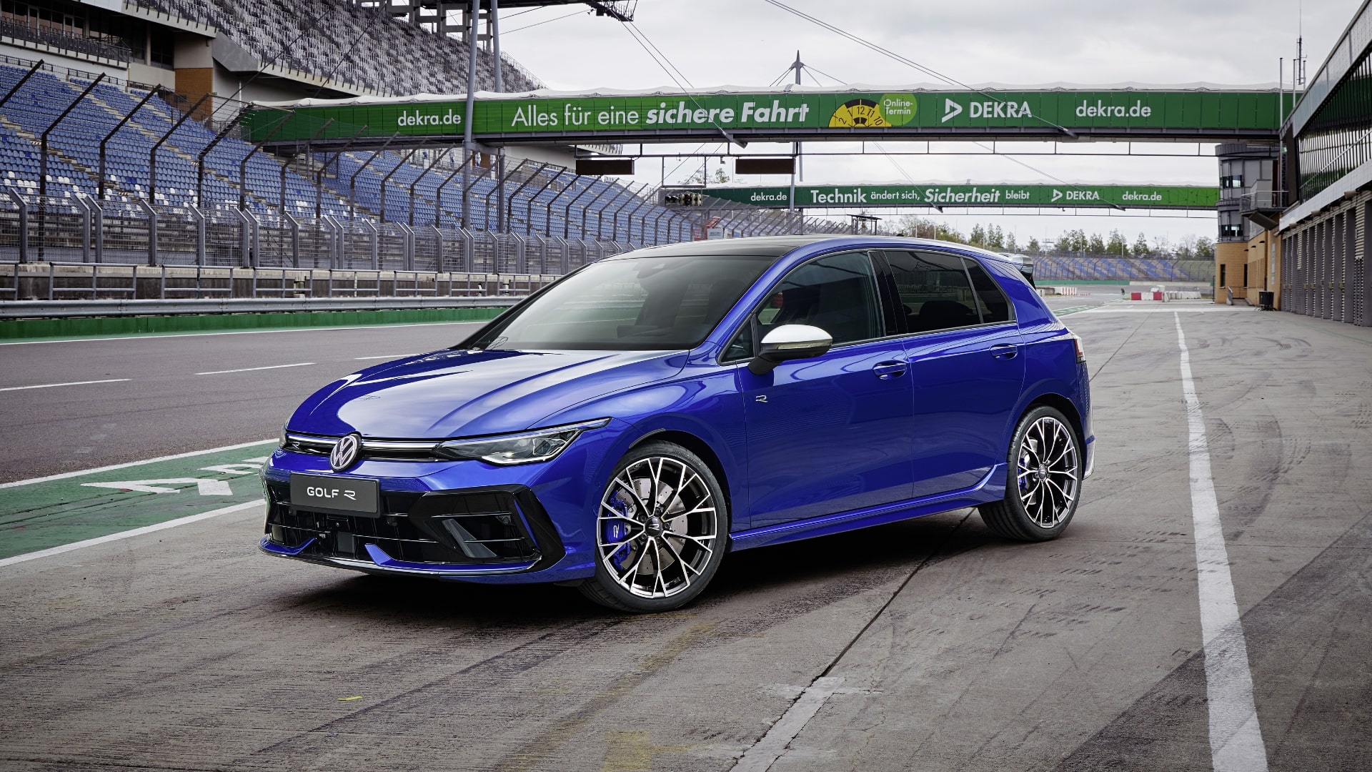 A blue Volkswagen Golf R with a rear spoiler for enhanced downforce and roadholding, shown on a racetrack.