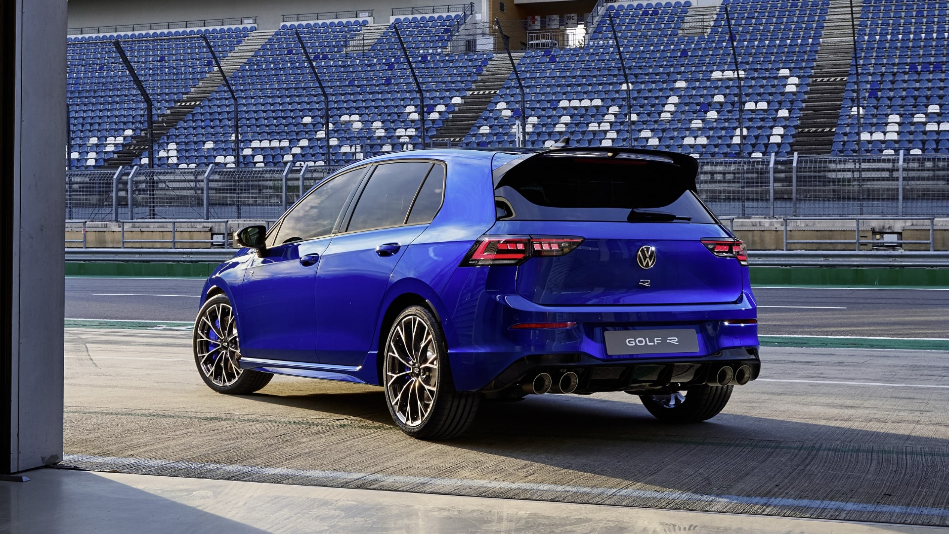 Blue Volkswagen Golf R with new taillights and quad exhaust.