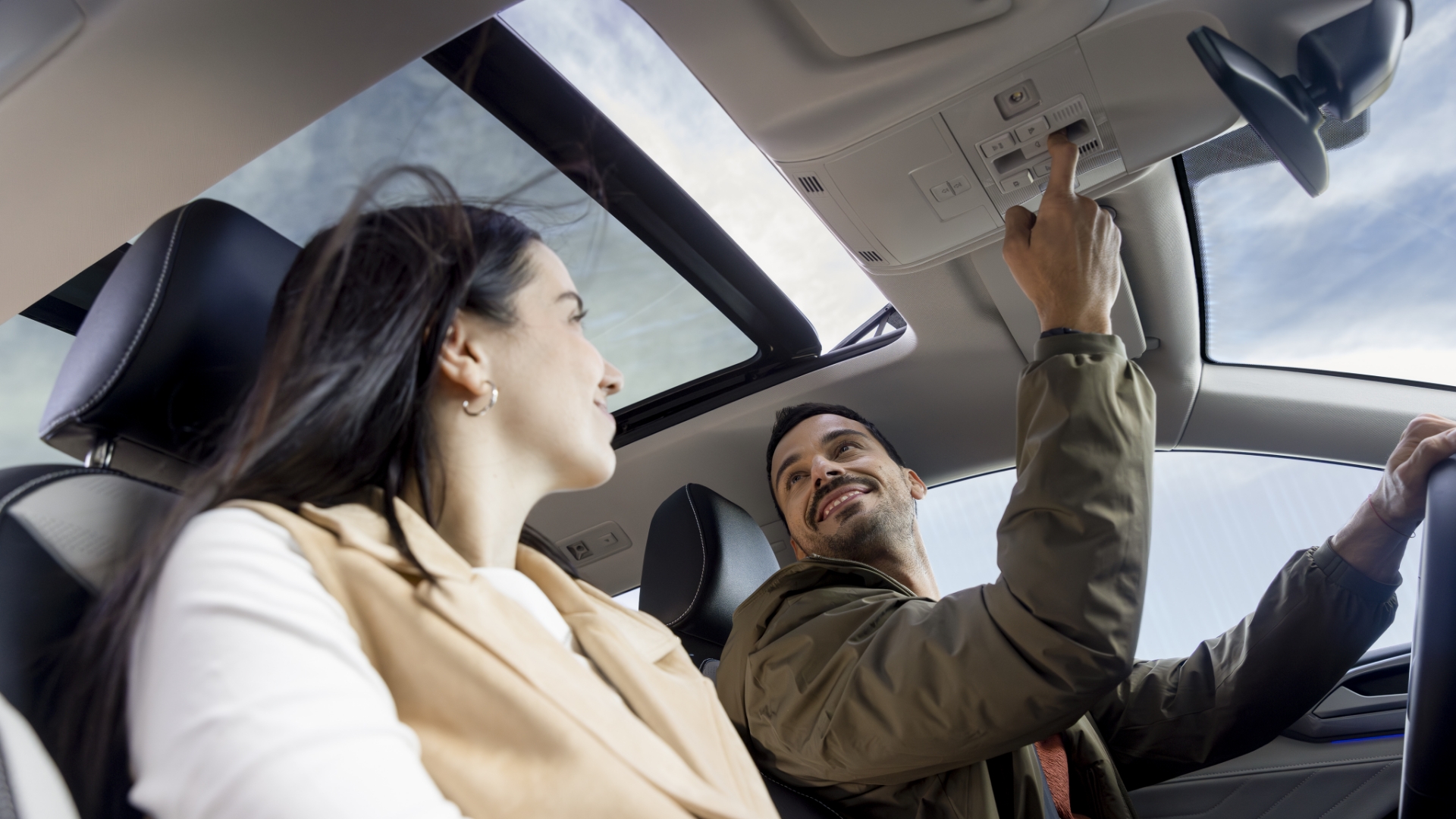 Passengers enjoying a panoramic sunroof in a 2025 Volkswagen Taos.