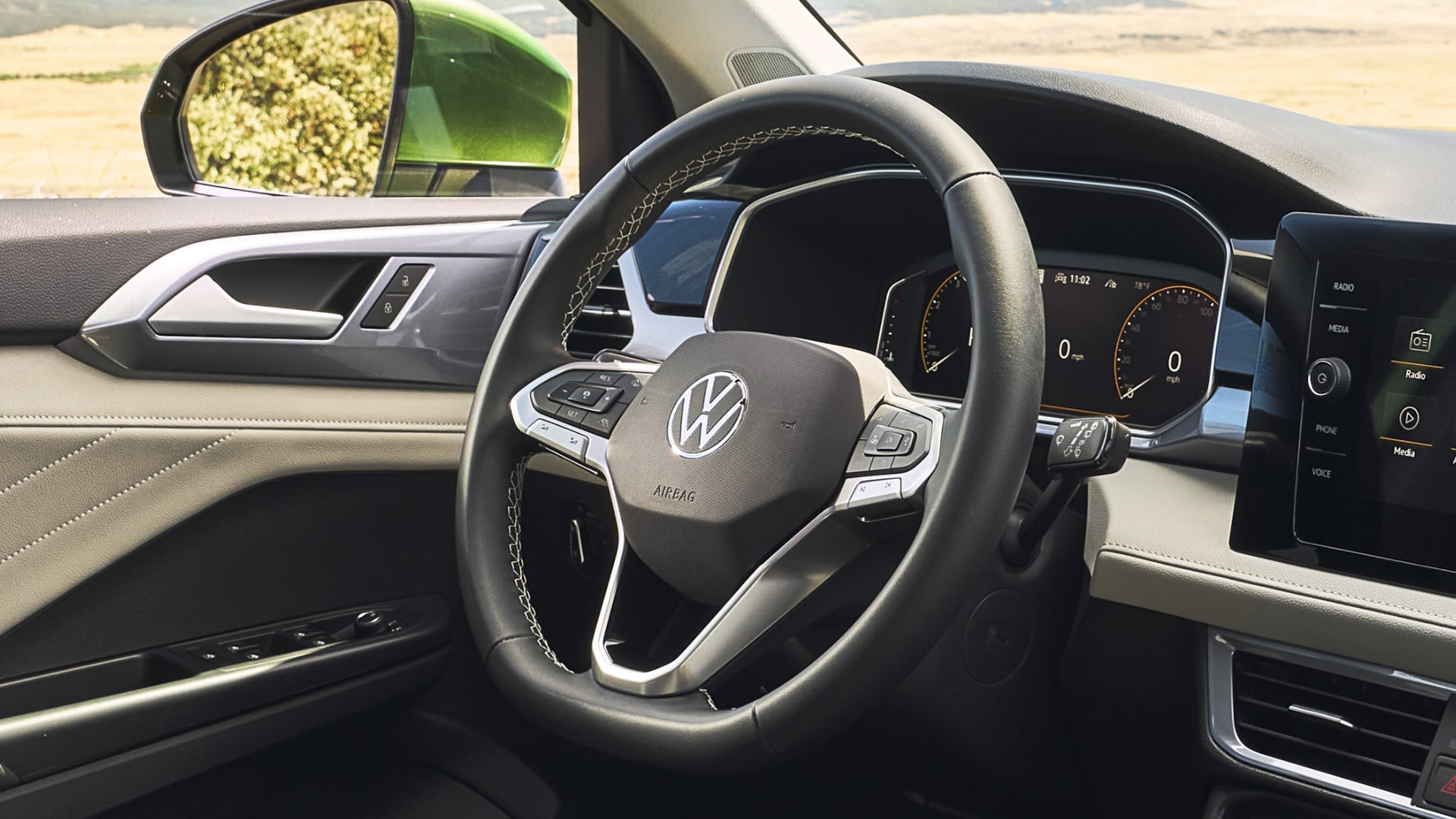 A stylish Taos 2025 steering wheel featuring the Volkswagen logo and leatherette material with heating functionality.