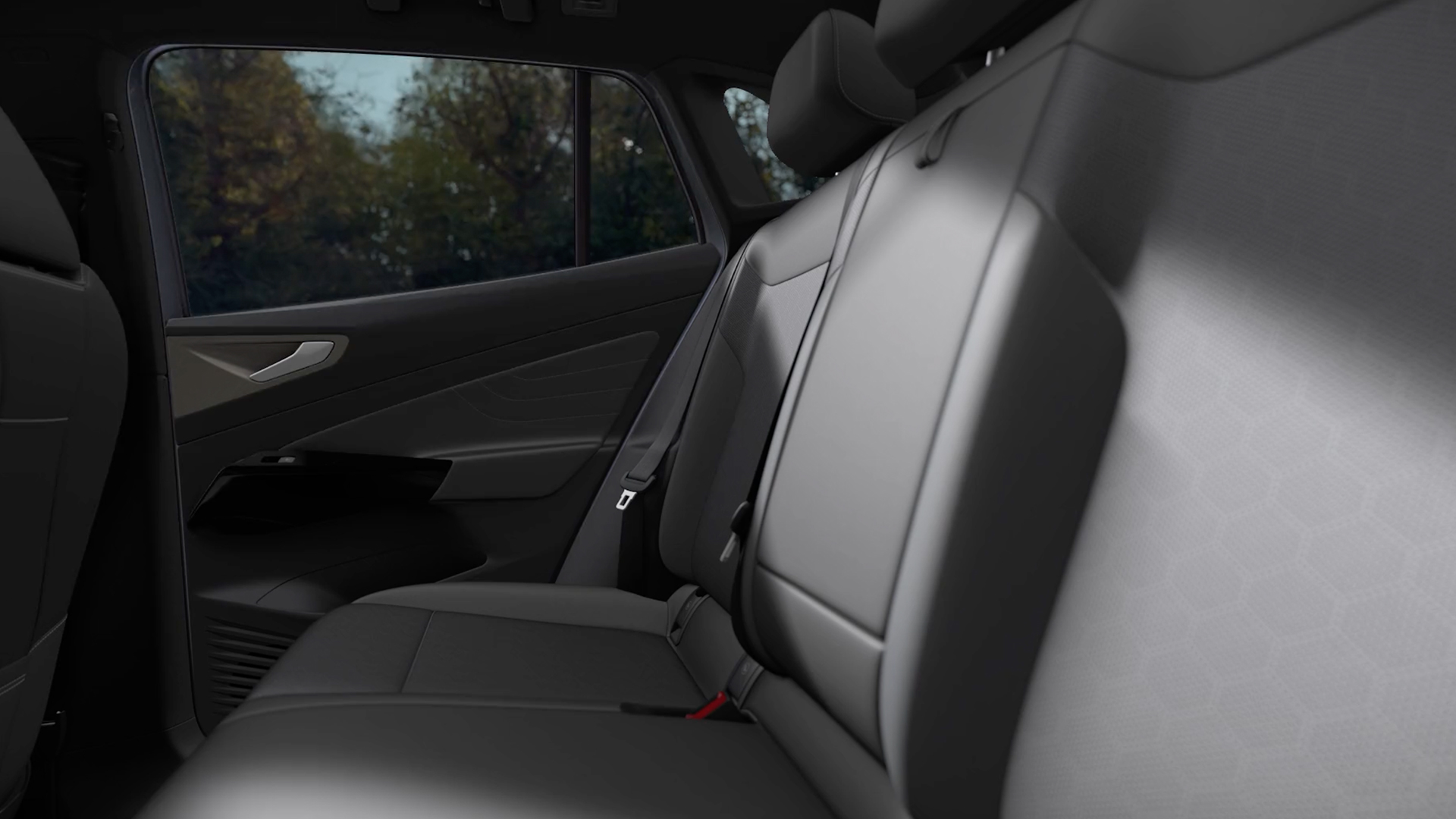 Rear view of black synthetic vinyl seats inside a Volkswagen vehicle.