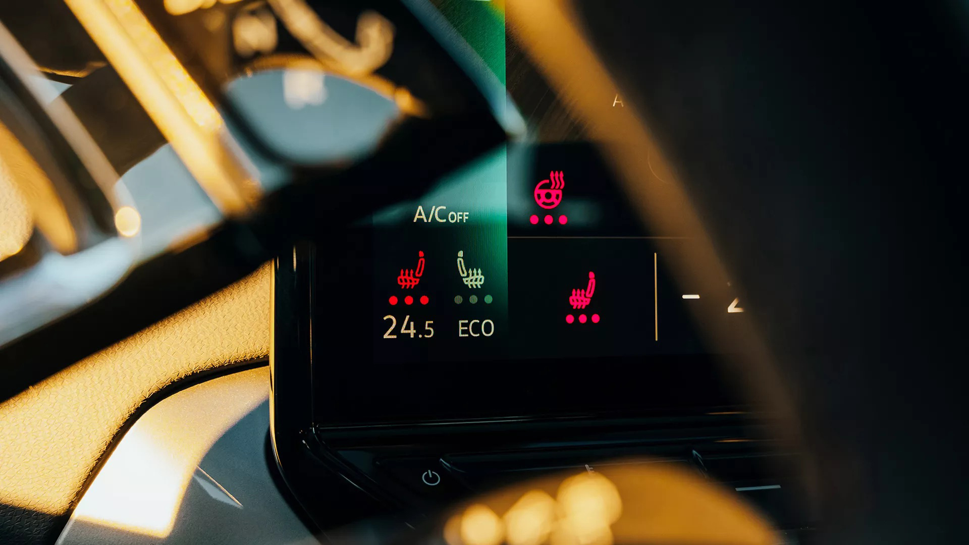 Close-up of a car's digital control panel showing the activated ventilated front seat feature.